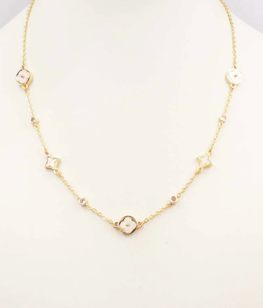 gold chain with white clovers